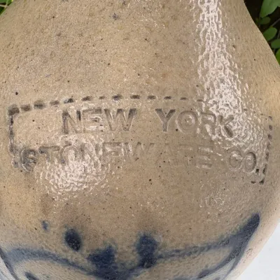 NEW YORK STONEWARE CO., HANDLED JUG WITH COBALT LEAVES