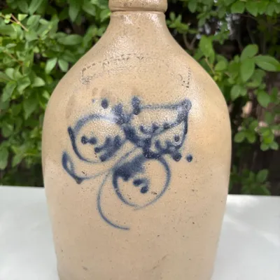 NEW YORK STONEWARE CO., HANDLED JUG WITH COBALT LEAVES