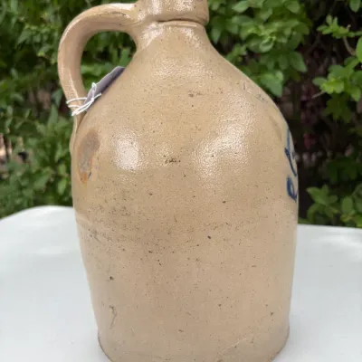 NEW YORK STONEWARE CO., HANDLED JUG WITH COBALT LEAVES