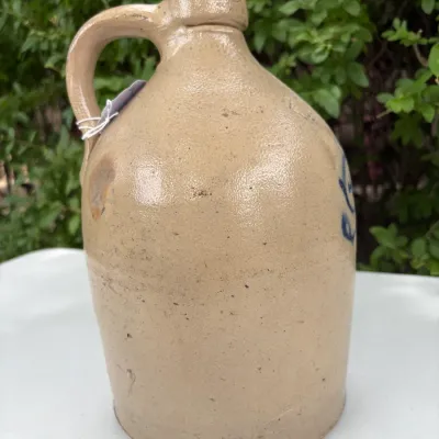 NEW YORK STONEWARE CO., HANDLED JUG WITH COBALT LEAVES