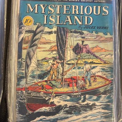 Classic Comics No. 34, "Mysterious Island" by Jules Verne, showing some wear and stored in a protective plastic sleeve.