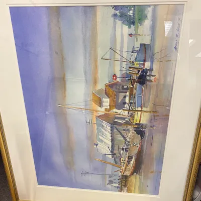 Framed watercolor painting depicting a harbor scene with boats and buildings, signed by Florian M. Wood and dated '95.