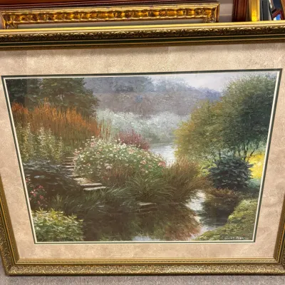 Large framed landscape print by Henry Peeters, depicting a lush garden path leading to a stream, housed in an ornate gold-finished frame...