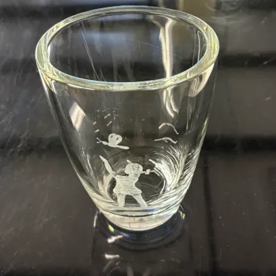 Vintage clear glass shot glass featuring an etched design of Tinker Bell and a butterfly.