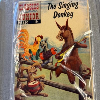 Classics Illustrated Junior comic book, No. 550, "The Singing Donkey," preserved in a protective plastic sleeve.