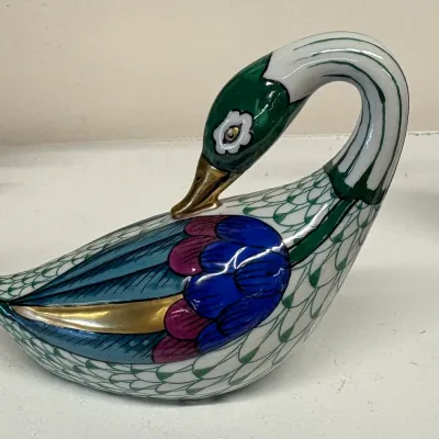 Vintage hand-painted porcelain swan figurine featuring vibrant blue, green, and gold accents with a stylized feather pattern.