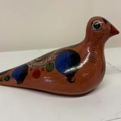Vintage Tonala Mexican folk art pottery bird figurine, hand-painted with floral and leaf motifs on a burnished terracotta body.