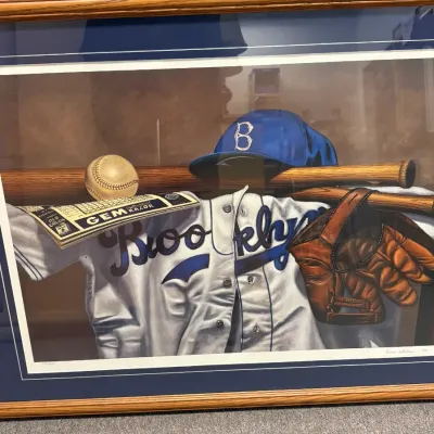 Framed and matted limited edition print depicting Brooklyn Dodgers baseball memorabilia, including a jersey, cap, glove, bat, and ball,...
