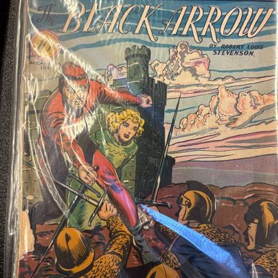 Classic Comics No. 31, "The Black Arrow" by Robert Louis Stevenson, preserved in a protective plastic sleeve.