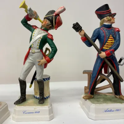 Pair of vintage Goebel  porcelain military figurines, featuring a French Cuirassier 1812 and an Artilleur 1805 on white bases with blue...