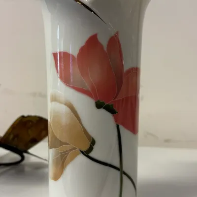 Vintage Kaiser porcelain vase featuring a stylized floral design in red and gold tones with a gold-trimmed, flared rim.