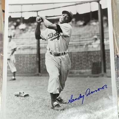Autographed black and white photograph of Brooklyn Dodgers outfielder Sandy Amorós in a batting stance, signed in blue ink.