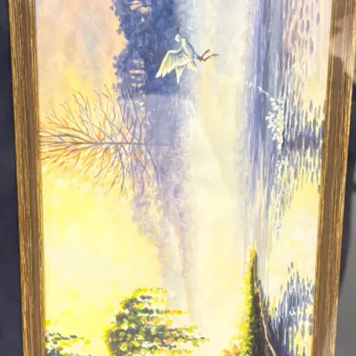 Framed landscape painting depicting a bird in flight over a misty lake at sunrise, signed by Mary Kokoski and dated '95.