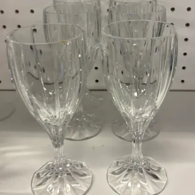 Set of six vintage crystal wine goblets featuring vertical cuts on the bowls and a decorative starburst pattern on the bases.