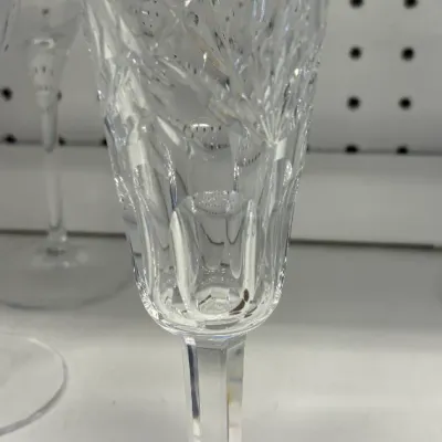 Vintage cut crystal Waterford champagne flute featuring a faceted stem and a starburst pattern on the base.