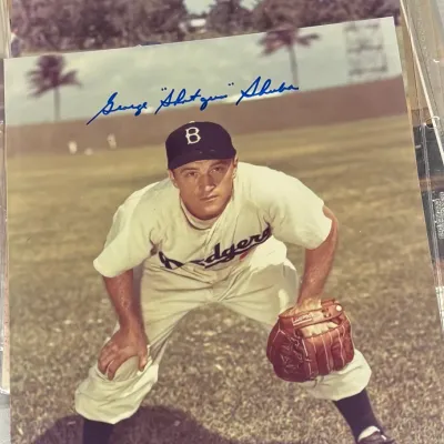 Autographed color photograph of Brooklyn Dodgers player George "Shotgun" Shuba, signed in blue ink across the top.