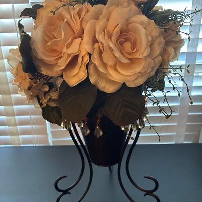 Sale Photo Thumbnail #541: Faux floral arrangement featuring peach and cream roses with greenery, housed on stand. Appears to be in good pre-owned condition with light surface wear.