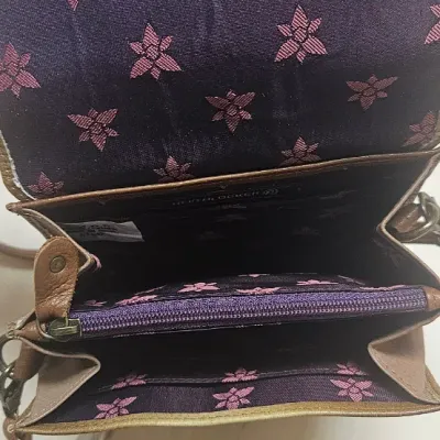 Sale Photo Thumbnail #89: Expertly crafted from genuine top grain leather, it features an accordion-style layout with RFID protection and multiple compartments, perfect for everyday use or travel. Length: 5.25" Width: 4" Height: 6" Adjustable Strap Drop: 13"to 26"