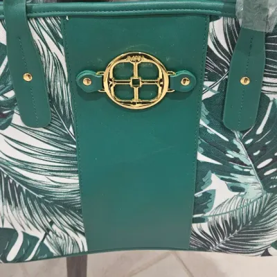 Sale Photo Thumbnail #200: 19 inches W x 12 inches H without Strap measurement. 21 inches with Strap. Green leaves on white with gold emblem