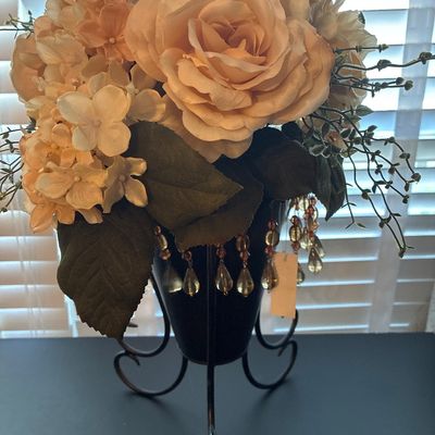 Sale Photo Thumbnail #542: Faux floral arrangement featuring peach and cream roses with greenery, housed on stand. Appears to be in good pre-owned condition with light surface wear.