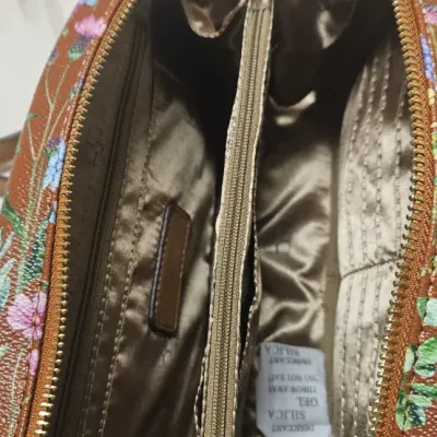 Sale Photo Thumbnail #94: Like New. New Iman Global Chic Floral crossbody purse-detachable adjustable strap 22" drop--Double zipper-- full pocket on front--inside signature lining -- credit card slots--middle pocket inside--and zip pocket inside--Cognac