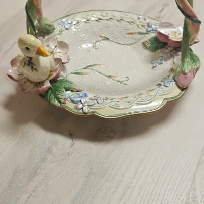Sale Photo Thumbnail #63: Vintage 1990s Fitz & Floyd "Garden Rhapsody" ceramic basket featuring a charming sculpted duckling resting among pastel floral and twisted vine details. Small chip on Flower. Please see pic.
