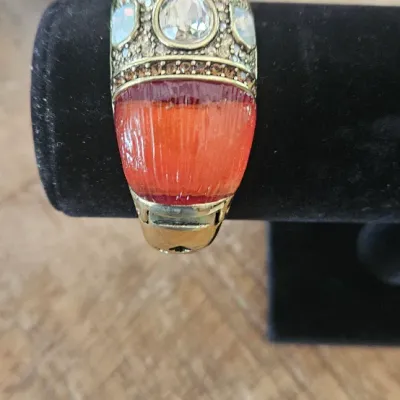 Sale Photo Thumbnail #187: Heidi Daus Signature Cuff Bangle Hinged Bracelet, heavily embellished with a striking combination of large teardrop, oval, and rectangular gemstones alongside intricate pavé crystal details.