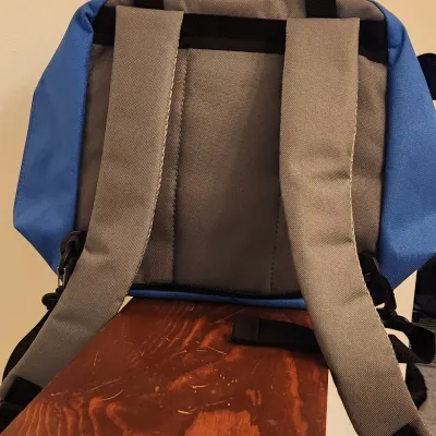 Sale Photo Thumbnail #346: Talon Outdoor Fishing Backpack (Upper) in a vibrant blue and grey color. Versatile outdoor bag features a durable canvas-like construction with a water-resistant interior lining, Includes a large main zippered compartment, a front hook-and-loop flap pocke