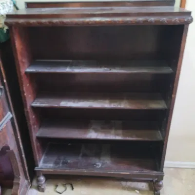 Sale Photo Thumbnail #41: Antique hard wood bookcase with carved top and turned feet