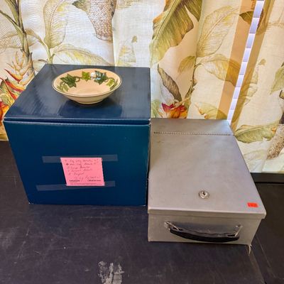 Vintage Franciscan Ivy pattern ceramic bowl displayed on a blue storage box, alongside a grey metal lockbox with a handle.