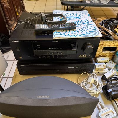 Yamaha Natural Sound AV receiver RX-V463 and CDC-506 compact disc player, shown with a Celestion speaker, remote control, and various...