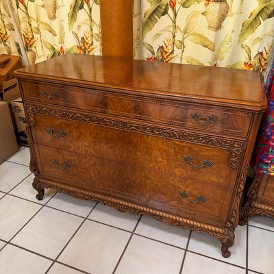 Vintage French Provincial style three-drawer dresser featuring rich burl wood veneers, ornate carved details, and brass hardware.