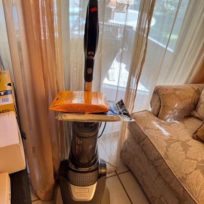 Electrolux Nimble upright bagless vacuum cleaner, shown with accessories resting on the dust bin.