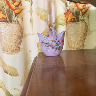 Vintage lavender porcelain basket vase featuring applied three-dimensional floral details and gold accents.