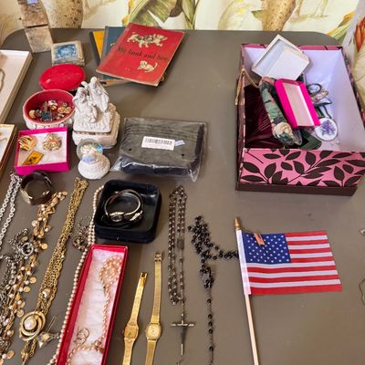 Assortment of vintage jewelry, watches, rosaries, and small collectibles, including a vintage children's book and a small American...