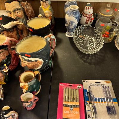 Assortment of vintage character jugs, including Royal Doulton style Toby mugs, displayed alongside blue and white transferware vases,...
