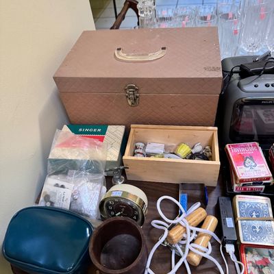 Assorted vintage items including a textured brown carrying case, a wooden box filled with small trinkets, a Singer sewing accessory box,...