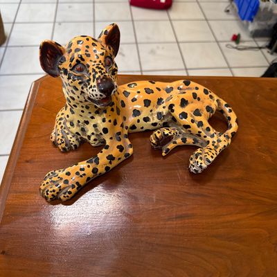 Vintage Italian ceramic leopard cub figurine in a reclining pose, featuring hand-painted spots and a glossy glaze finish.