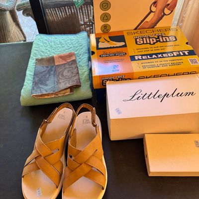 Assortment of household items and footwear, including a pair of tan Time and Tru sandals, a Skechers Slip-ins shoe box, a Littleplum box,...