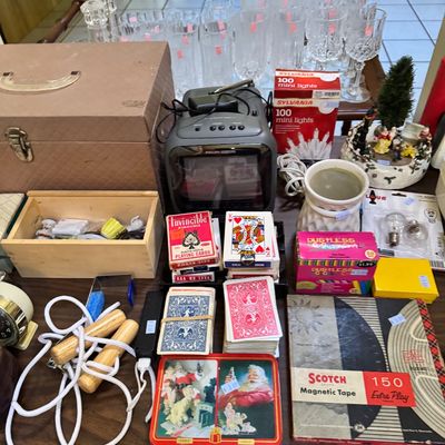 Assorted vintage household items including a small portable television, playing cards, a jump rope, Scotch magnetic tape, and glassware.