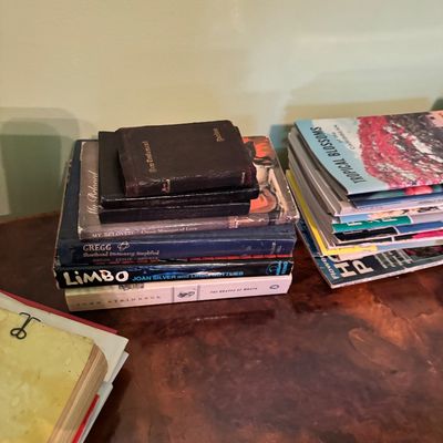 Two stacks of vintage books and magazines, including a Gregg Shorthand Dictionary and a copy of "Limbo" by Joan Silver and...