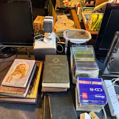 Assorted vintage religious books, including "The Living Bible" and "New Songs of Inspiration," displayed alongside...