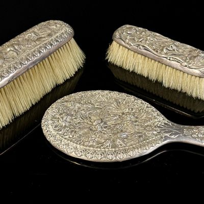 A Three-Piece Gorham Manufacturing Company Sterling Silver Floral Repousse Vanity Dresser Set
