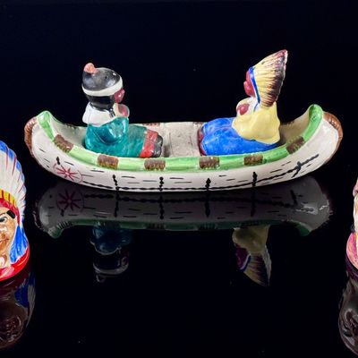 A Set of Four Japanese Hand Painted Ceramic Native American Souvenir Salt and Pepper Shakers and Canoe Base