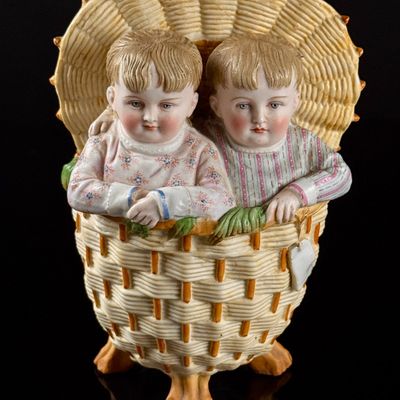 Late 19th-Century German-Style Hand-Painted Bisque Porcelain Figurine of Twins in a Hooded Basket