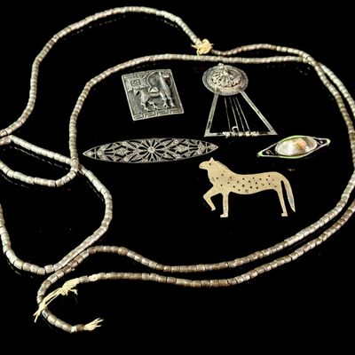 A Collection of Silver Jewelry Including Art Deco Style Brooches and Tribal Style Beads