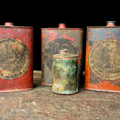 An Assortment of Antique Hazard Powder Co. and DuPont Gunpowder Tins