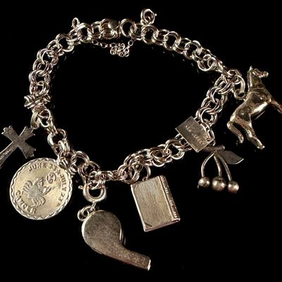 Sale Photo Thumbnail #23: A Sterling Silver Double-Link Charm Bracelet with Multiple Charms