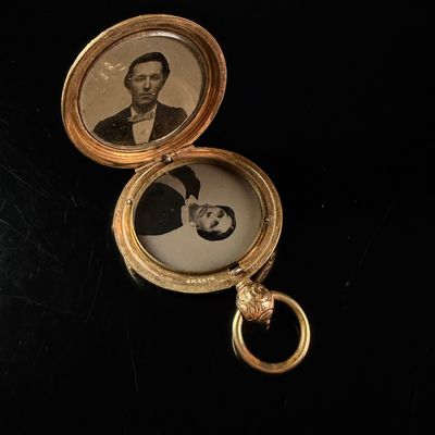 Sale Photo Thumbnail #206: A Victorian Gold Plated Double Tintype Portrait Locket