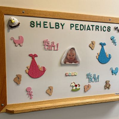 Sale Photo Thumbnail #84: Quartet Wood-Framed Magnetic Whiteboard with a Collection of Pediatric Themed Magnets